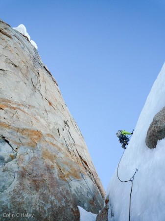 Chad down-climbing to a rappel anchor with the east headwall above